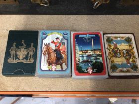 Three packs of vintage unopened playing cards depicting the Queen taking a salute at Trooping the Co