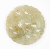Chinese jade or green hardstone carved disc with bird and flower decoration