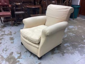 Edwardian deep upholstered easy chair with cream upholstery on bun feet