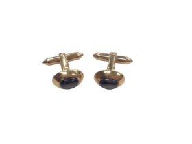 Pair of 18ct gold cufflinks, each oval panel set with a dark grey cabochon