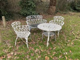 Victorian style cast metal garden suite comprising bench, pair of chairs and a table