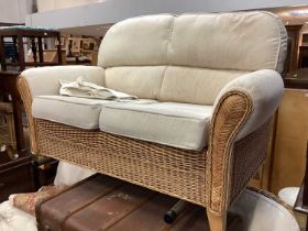 Wicker conservatory set comprising of a two seater sofa, two armchairs and a glass topped table