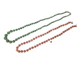 Green jade/ hard stone graduated bead necklace and an angel skin coral bead necklace (2)