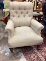 Victorian armchair with buttoned cream upholstery on turned front legs