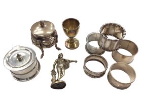 Group of five silver napkin rings, silver gilt egg cup, silver mustard pot, one other white metal