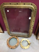 Two brass ship's port holes and a brass framed glass ship's window panel (3)