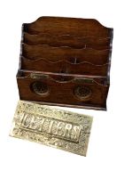 An Edwardian oak stationery rack with brass 'Post' and 'Delivery' labels, and an Edwardian brass let