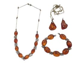 Silver mounted amber necklace and bracelet, together with two amber pendants