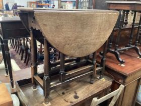 Antique oak oval drop leaf table with end drawer on turned and block legs joined by stretchers, 90cm