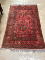 Eastern rug with geometric decoration on red ground, 158cm x 101cm