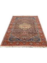 Eastern rug with central medallion on red and blue ground, 220cm x 110cm