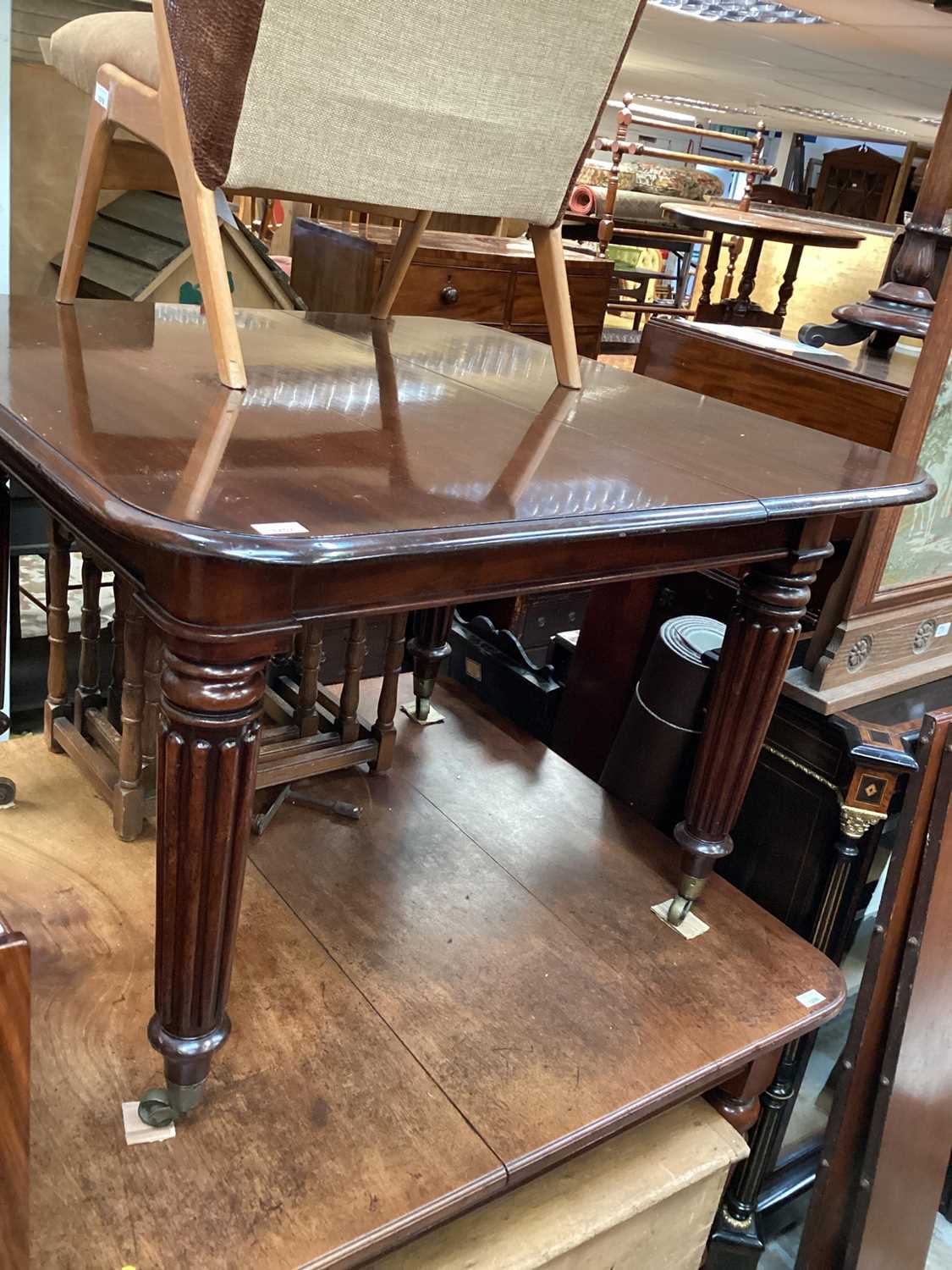 Victorian mahogany extending dining table with three extra leaves on turned reeded legs, 107cm x 104