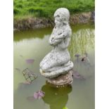 Weathered concrete garden pond fountain in the form of a kneeling lady