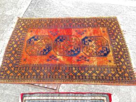 Eastern rug with three central medallions on burnt orange ground, 150cm x 100, together with three o