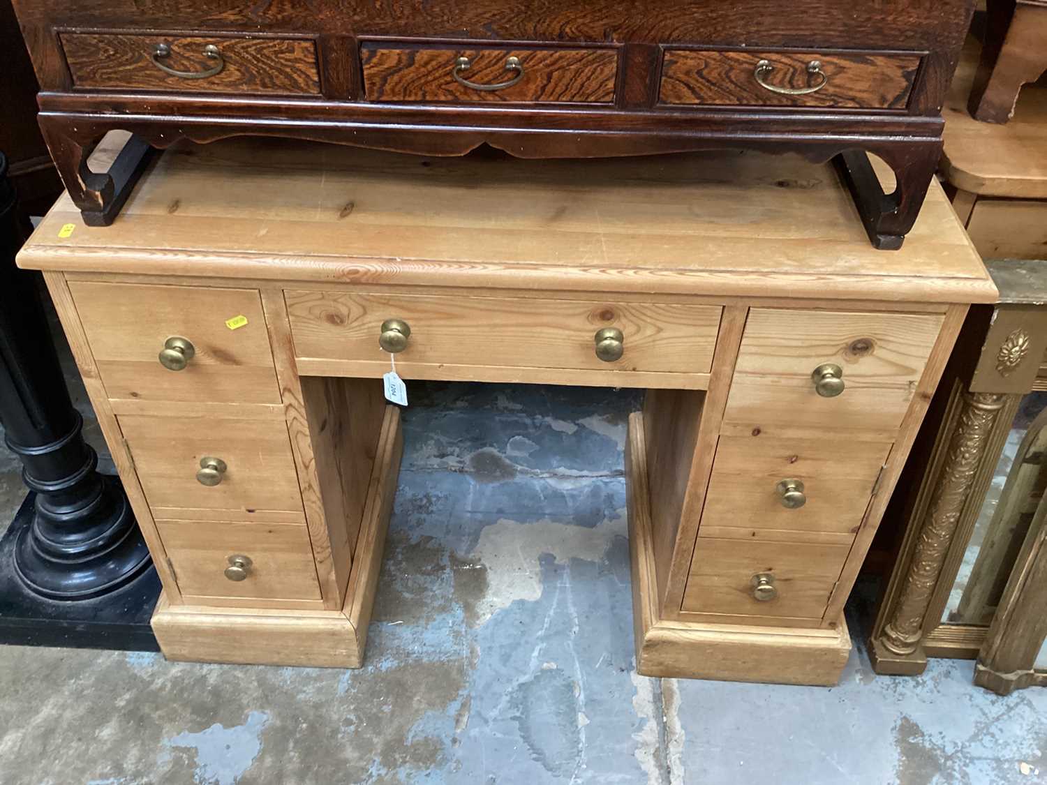 Victorian-style pine kneehole desk with an arrangement of cupboards and drawers