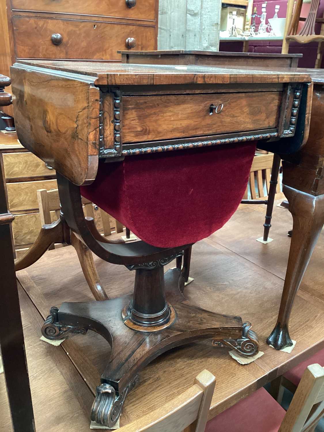 Victorian rosewood needlework table with single drawer and pull out well below on turned column and