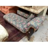 Victorian mahogany framed chaise longue with floral upholstery on turned legs and castors