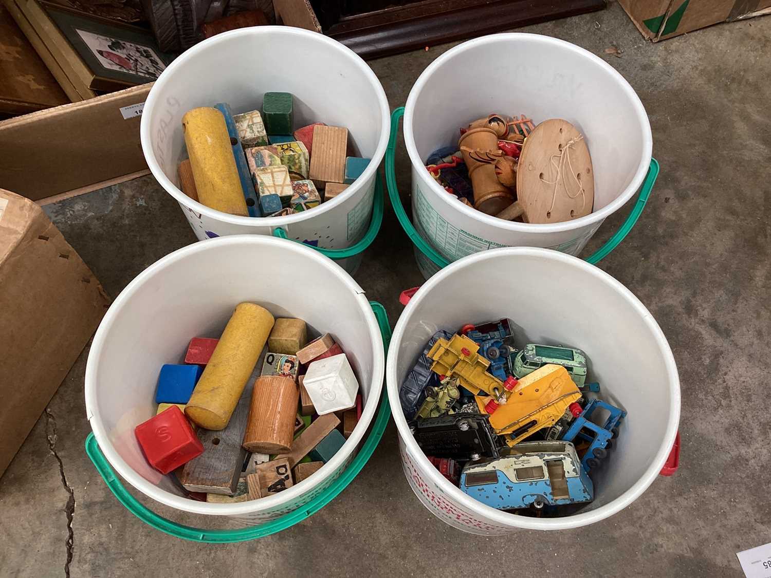Circular tubs of toys and boxed toy cars