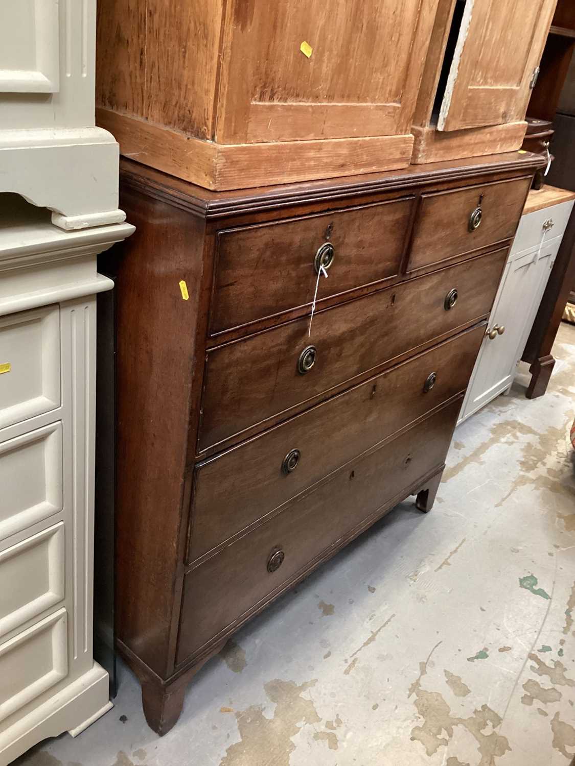 George III mahogany chest of two short and three long drawers with brass ring handles, on bracket fe