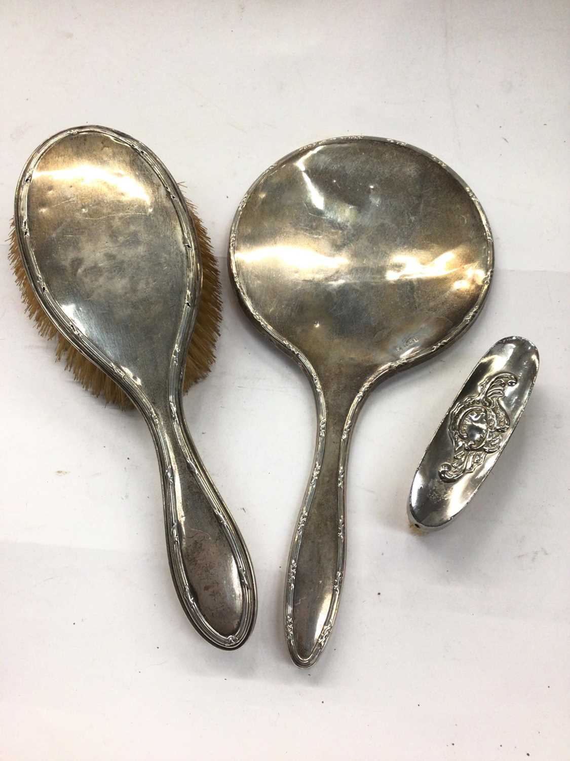 Silver backed hand mirror and brush, together with a small plated brush