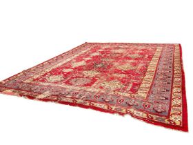 Antique Heriz style carpet, with angular medallions on brick red ground, in meander borders, approxi