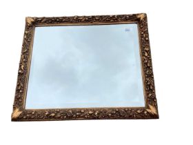 Gilt framed wall mirror in ornate frame, 53cm x 64cm