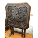Eastern folding table with carved top depicting figures and buildings, together with an eastern octa