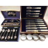 Four silver napkin rings, jewellery, plated souvenir spoons and a mother of pearl handled plated kni