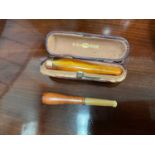 9ct gold mounted amber cheroot and another cheroot (2)