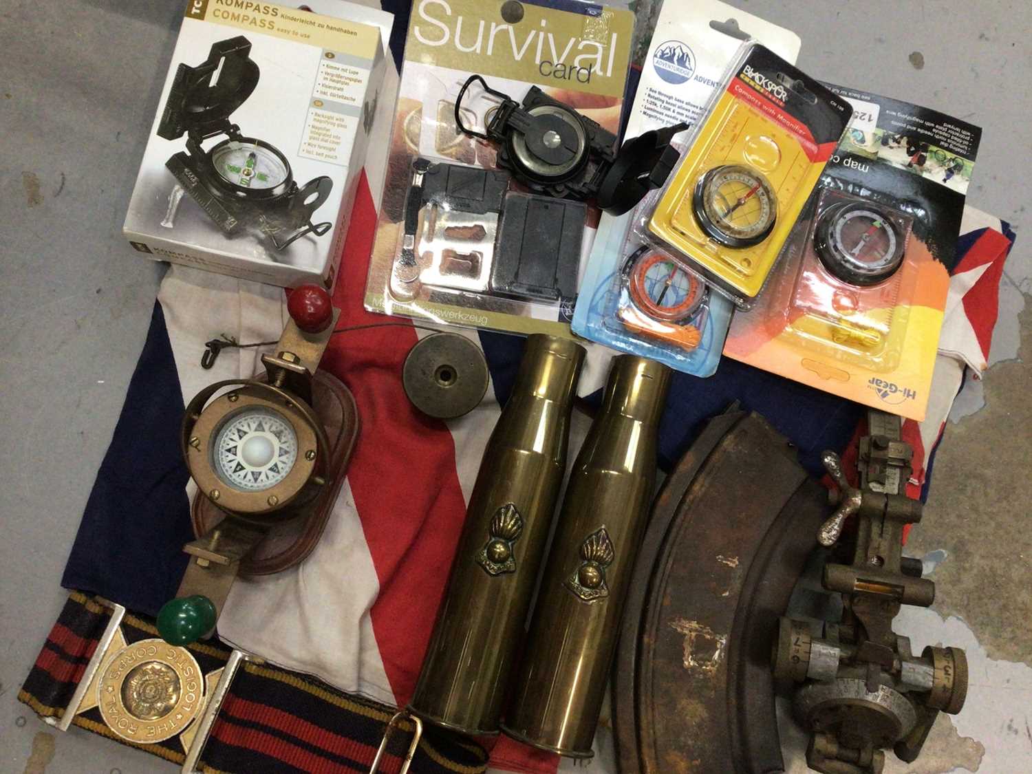 Pair of brass shell cases, The Royal Logistic Corps belt, gun magazine, two Union Jack flags and a s