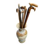 Walking sticks in a pottery vase