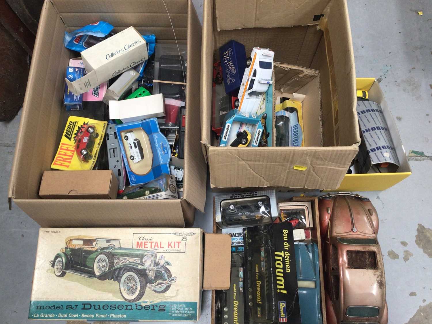 Three boxes of various toy cars and vehicles