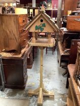 Hand made wooden bird house and feeder on stand