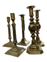 Pair of George III brass candlesticks, another and pair of Victorian candlesticks