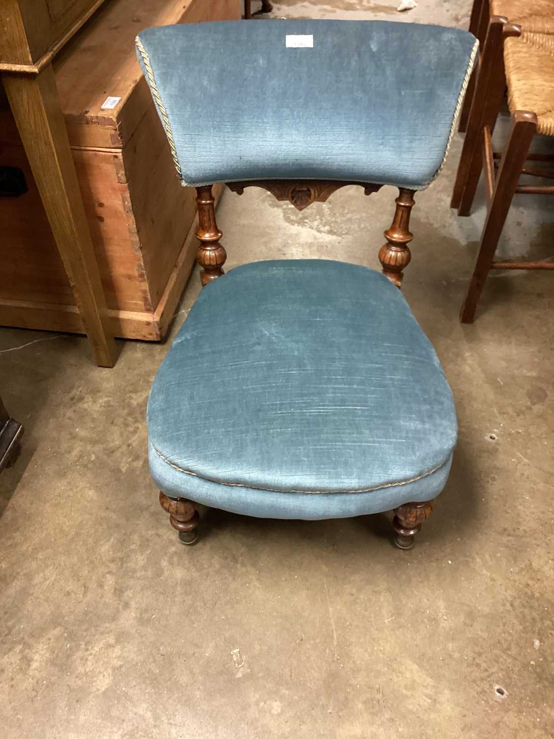 Victorian mahogany nursing chair with blue upholstery on turned front legs