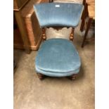 Victorian mahogany nursing chair with blue upholstery on turned front legs