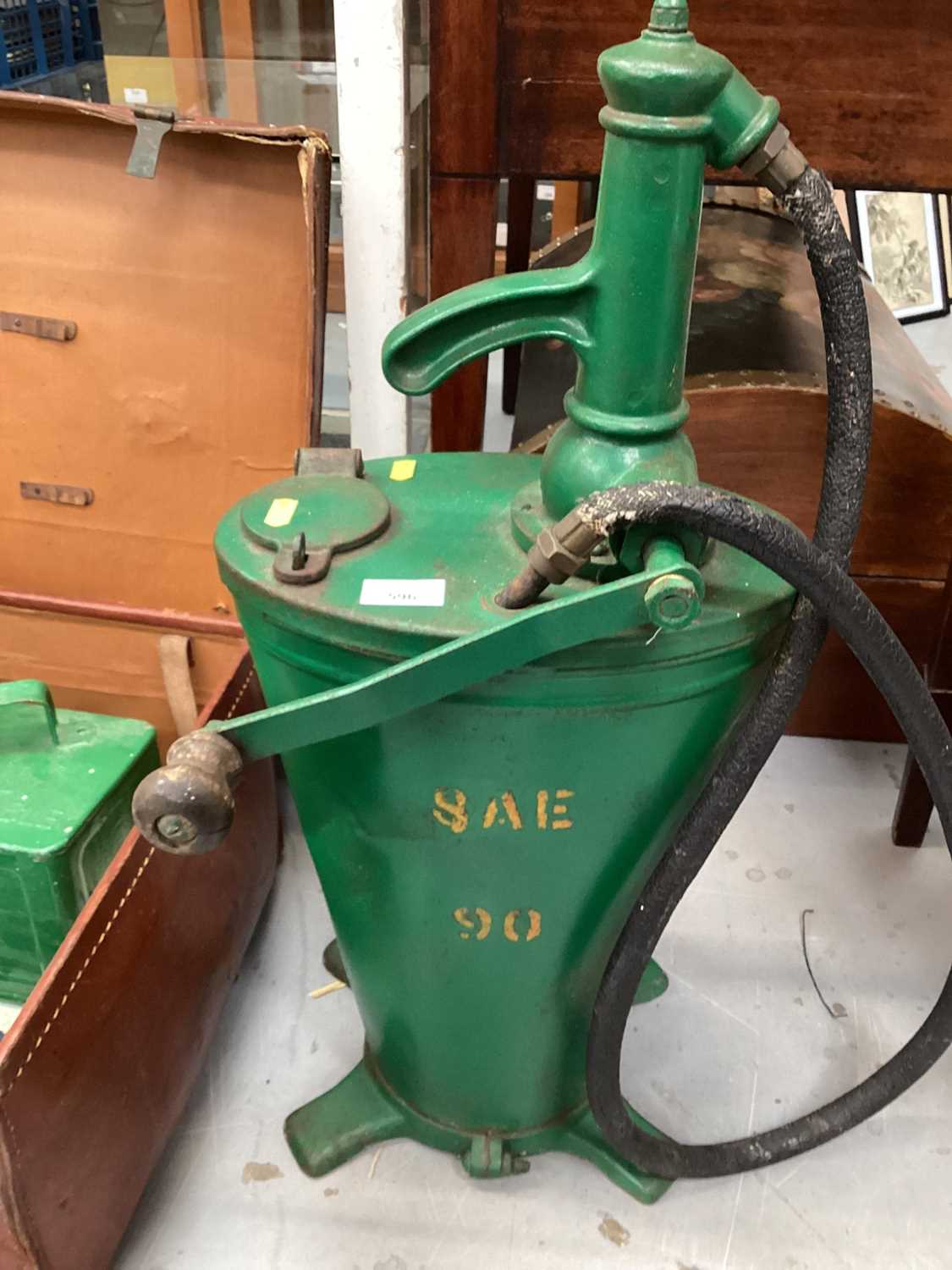 Automobilia including a vintage agricultural oil dispenser, modern jerrycan in the form of traffic l