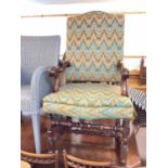 Antique high back elbow chair with geometric upholstery on turned and block legs joined by stretcher