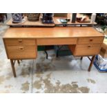 Mid century teak five drawer kneehole desk/dressing table, bearing label Alfred Cox Furniture, 137cm