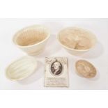 Four jelly moulds and a Wedgwood printed commemorative plaque