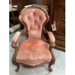 Victorian heavily carved mahogany open arm chair with velvet upholstery