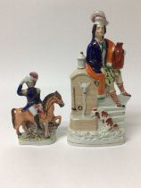Staffordshire pottery figure of a Highlander with a spaniel at a well, and another of a figure on ho