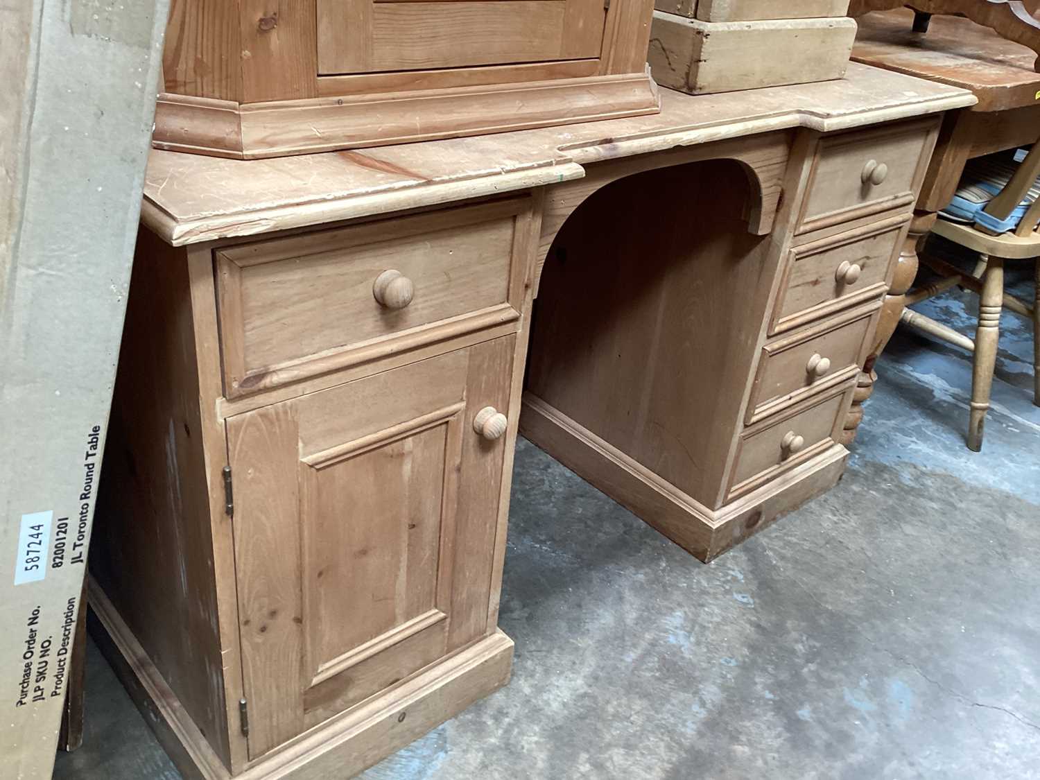 Pair of Victorian-style pine kneehole desks, each with five drawers and a single cupboard