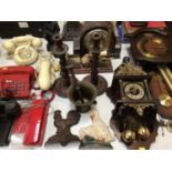 Group of vintage telephones, three wooden clocks, pair of barley twist candlesticks, box of brasswar