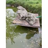 Three weathered concrete garden fountains in the form of frogs