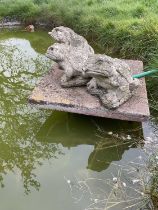 Three weathered concrete garden fountains in the form of frogs
