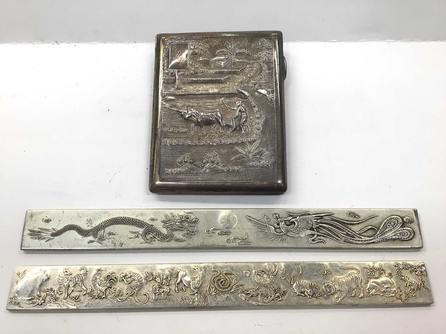 Burmese silver cigarette case with farming scene decoration, together with a pair of Chinese silver