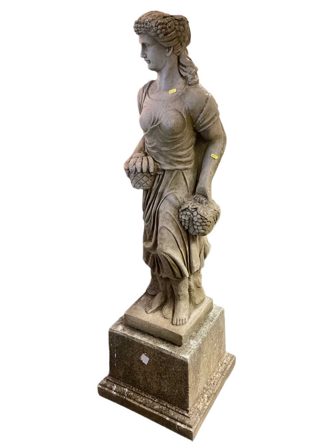 Concrete garden statue of a lady carrying fruit on plinth base, 154cm high