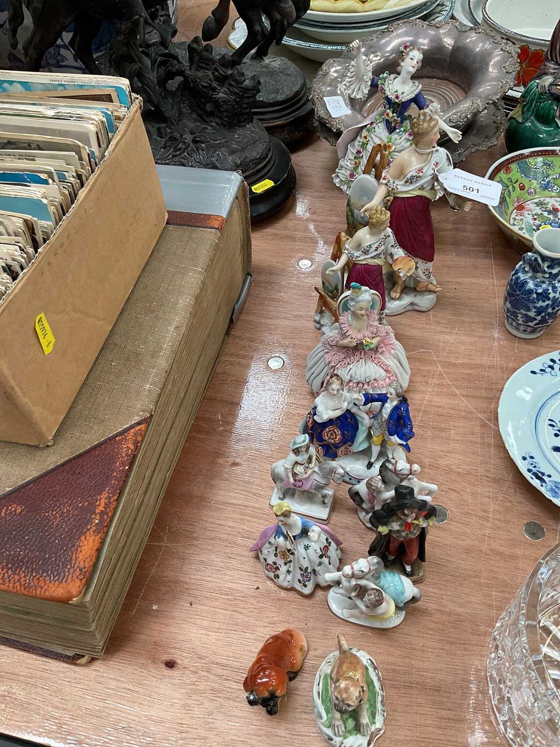 Group of porcelain figurines and pair of plated wine coasters