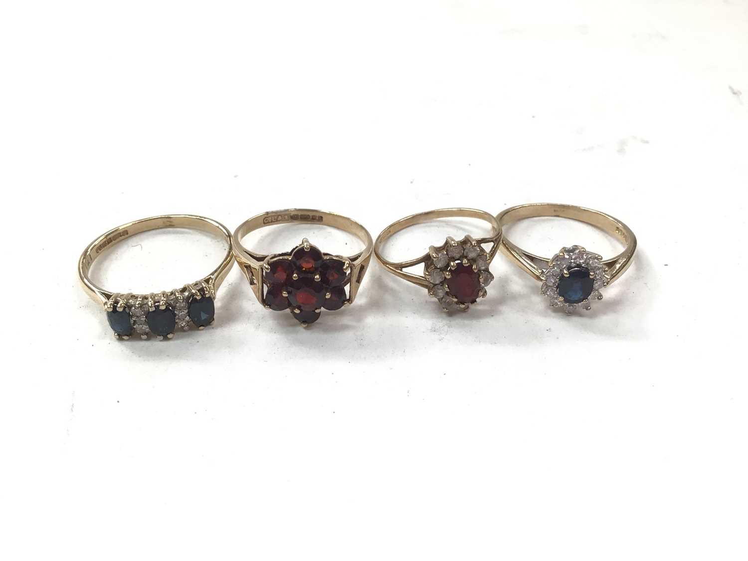 Four 9ct gold gem set dress rings